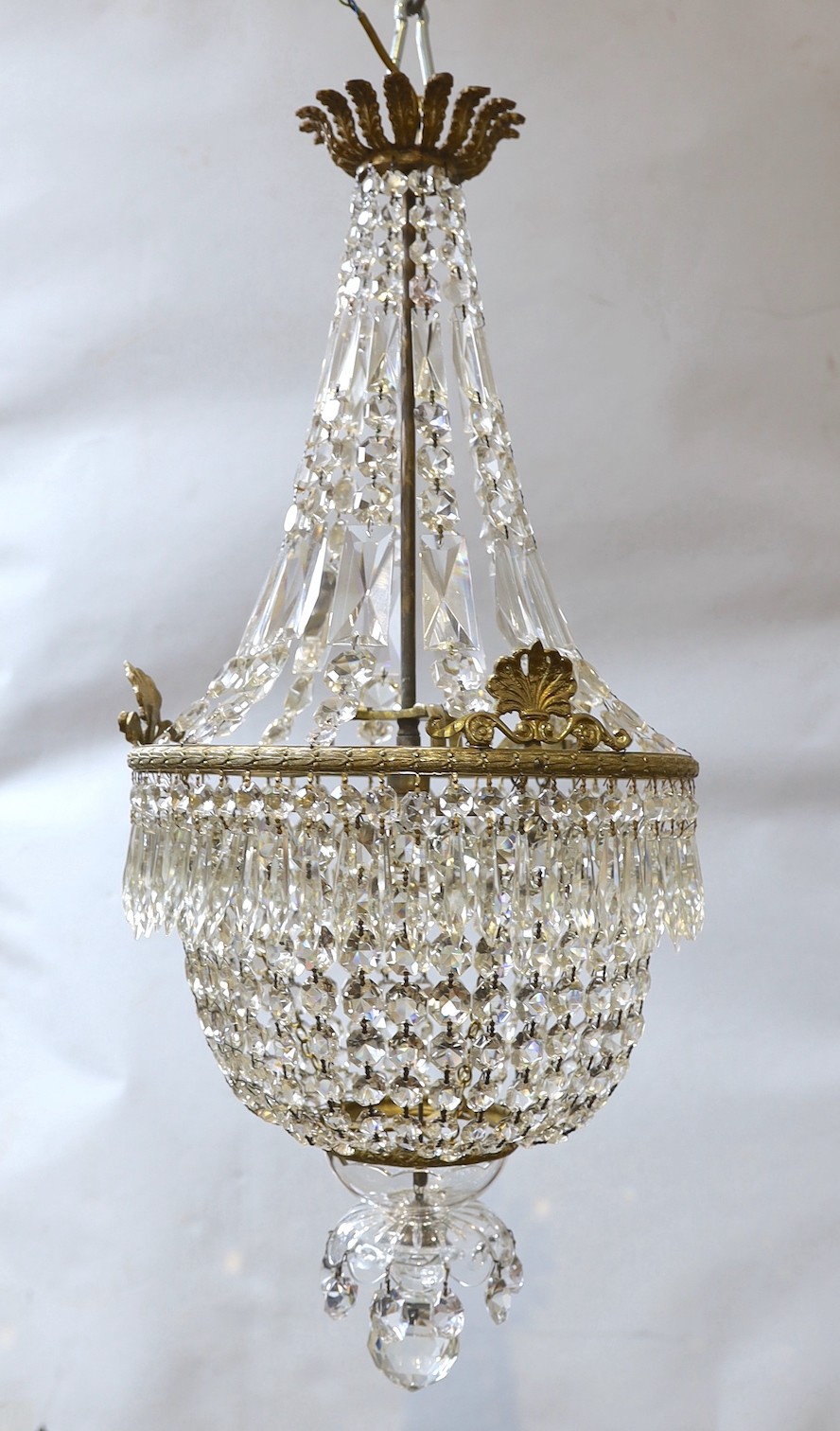 A brass bag shaped ceiling light hung faceted bead and spear drops, height approximately 80 cms.